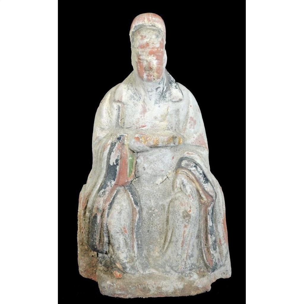 Seated 17th century Ming Dynasty terracotta court figure statuette with faded paint on black background.