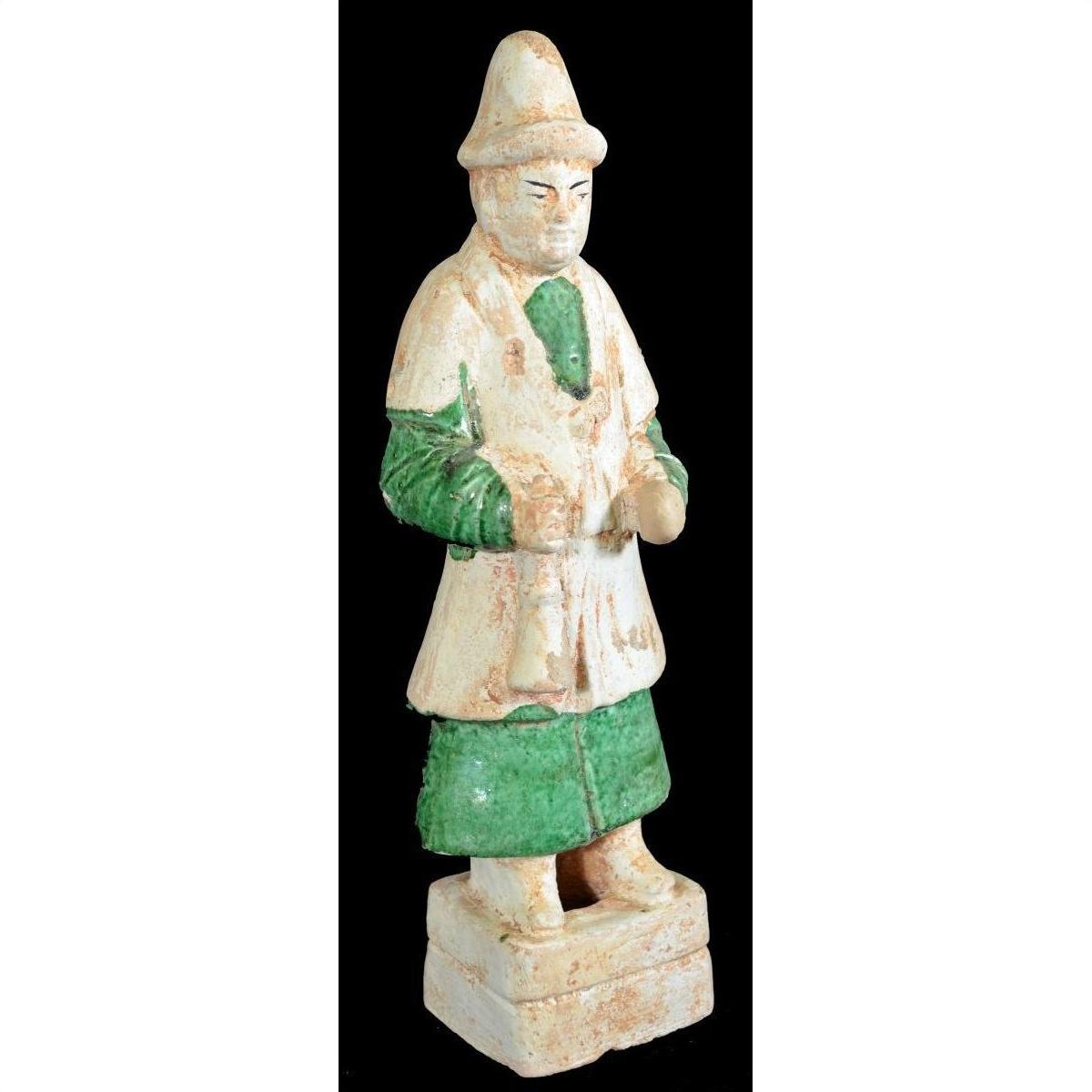 Terracotta Ming Dynasty figure with conical hat, green pants, and white tunic, close-up view.