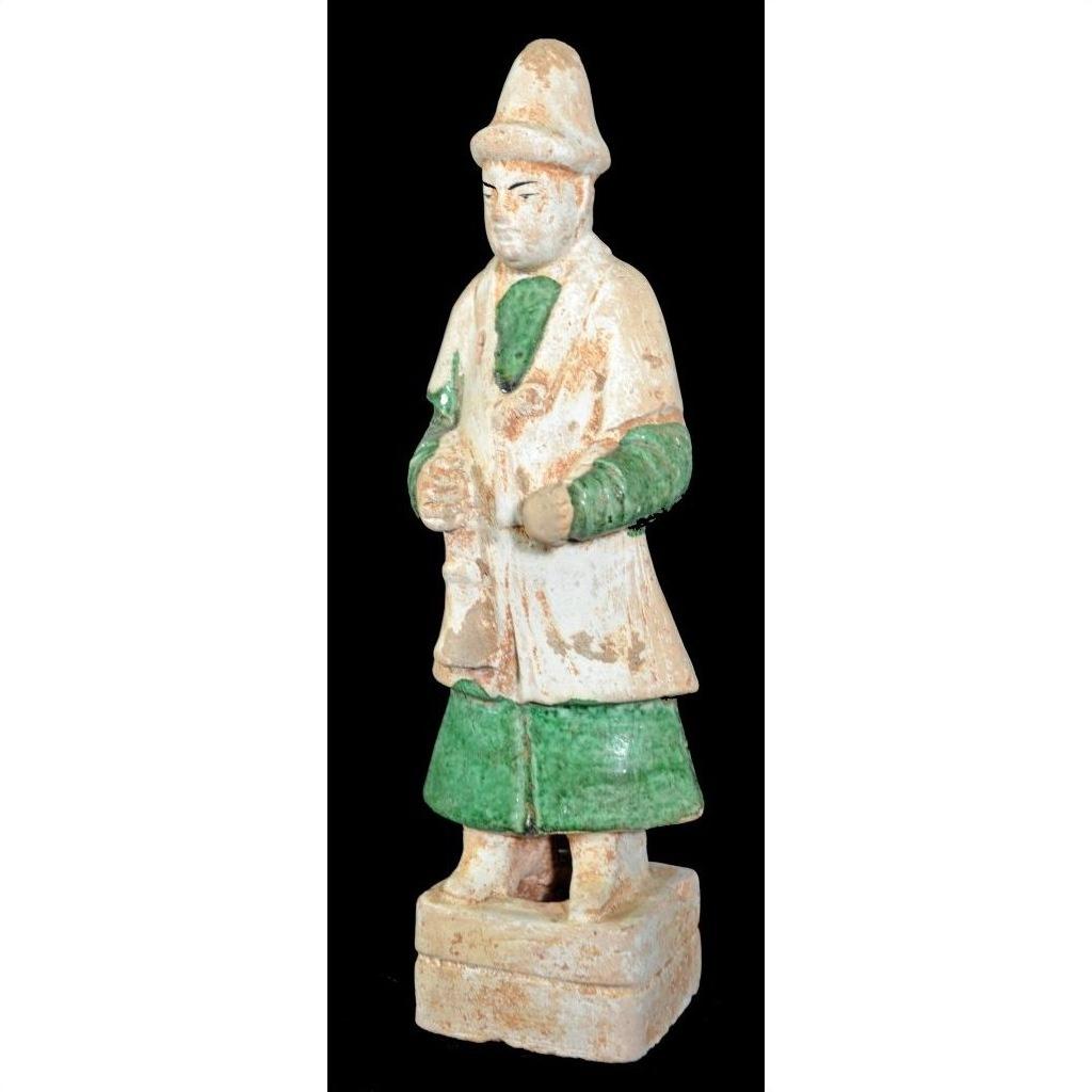 Terracotta Ming Dynasty court figure in hat and robe with green sleeves, on rectangular base, close-up.