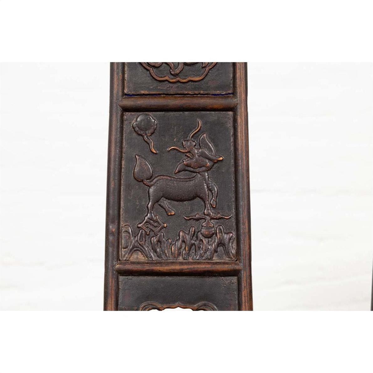 Brown elmwood panel with carved prancing deer, grass, and floating orb, from Chinese Ming Dynasty chair.