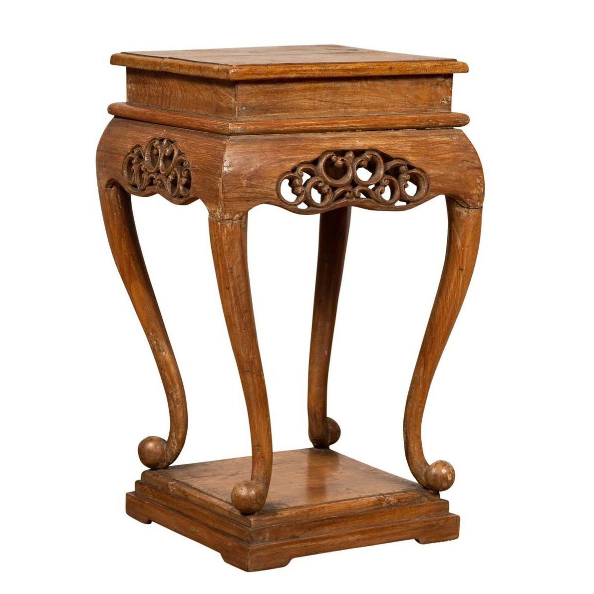 Brown wood Ming style incense stand with cabriole legs, carved apron, square top and base, shown on plain background.