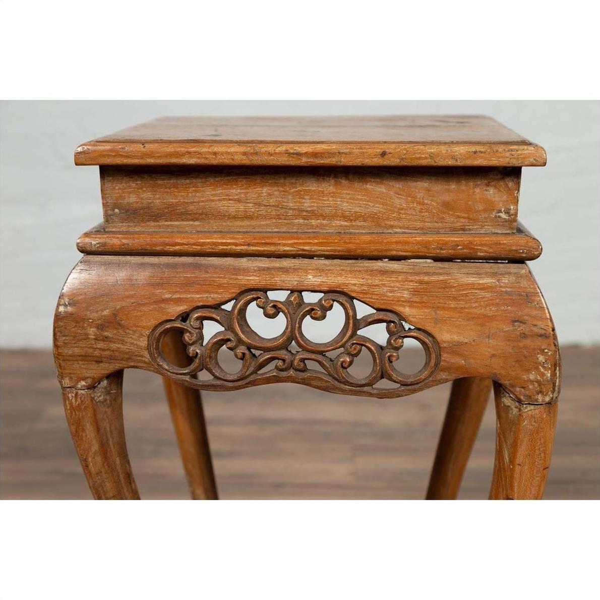 Brown wooden incense stand with cabriole legs and carved apron, rustic finish, Ming style, photographed indoors.