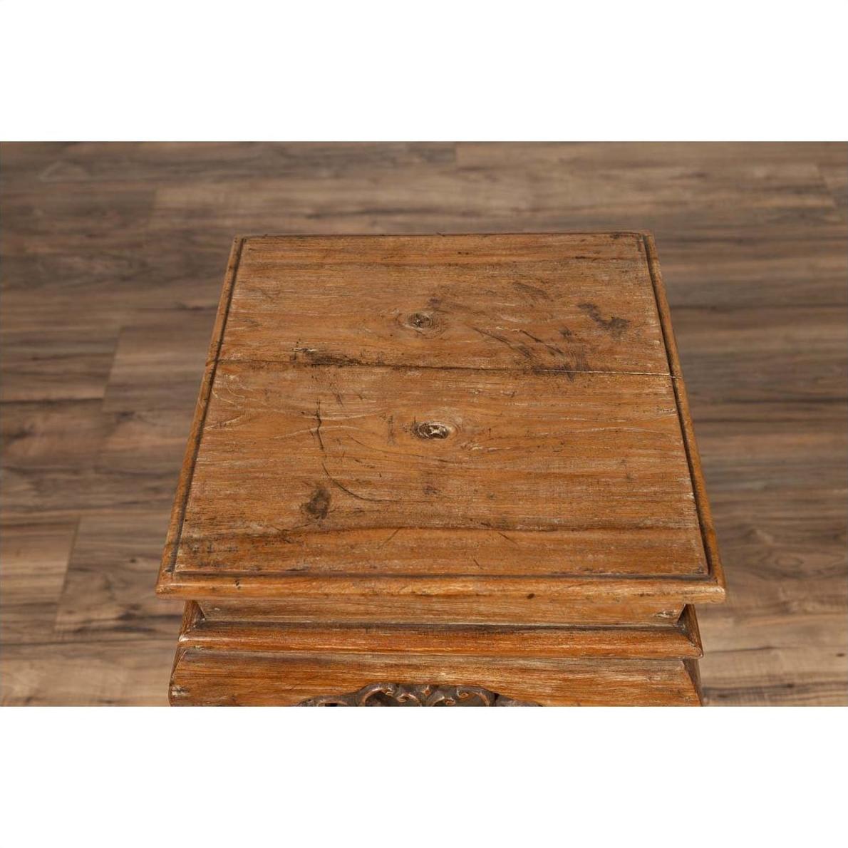 Brown wooden incense stand with cabriole legs, Ming style, on wood-patterned floor indoors.