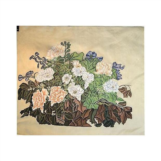 Beige silk with embroidered white and peach roses, green leaves, and purple flowers, close-up.