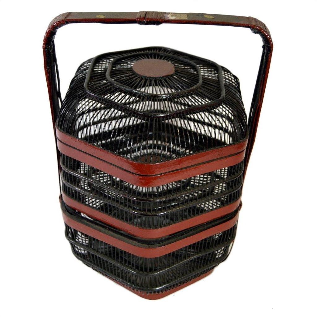 Close-up of black and red hexagonal Chinese picnic basket with three stacked tiers and large top handle.
