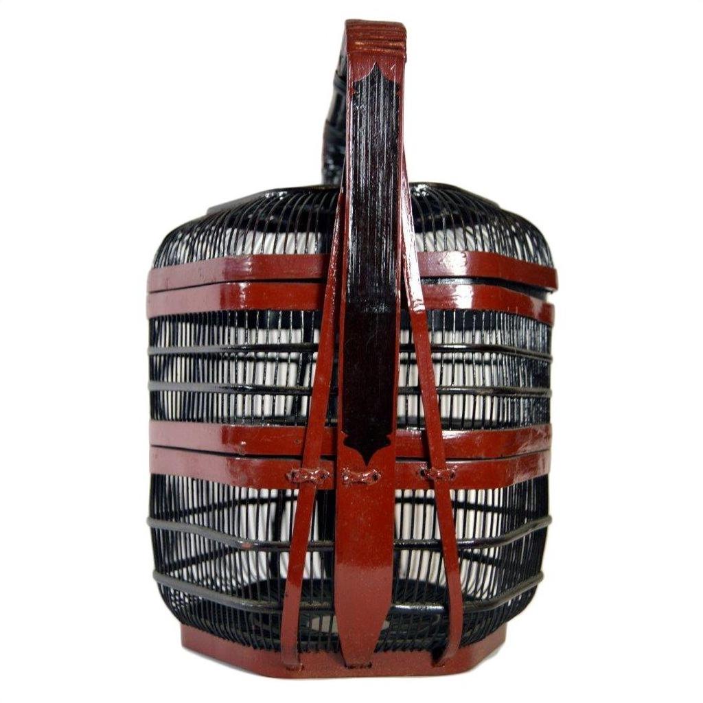 Black and red Chinese picnic basket with tall central handle, front view, in very good condition.