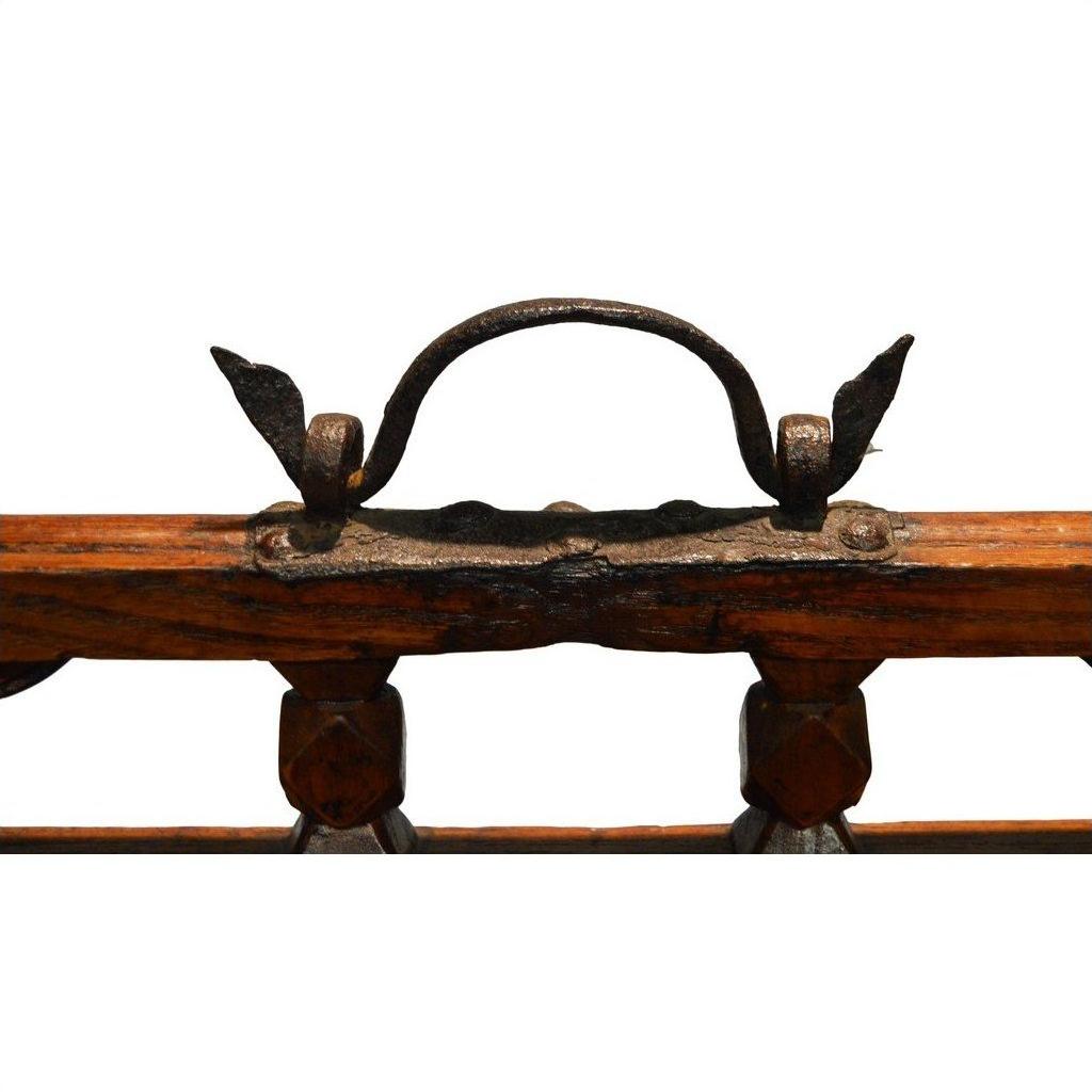 Close-up of rustic metal handle with vintage decorative accents on wood, Chinese picnic box detail.