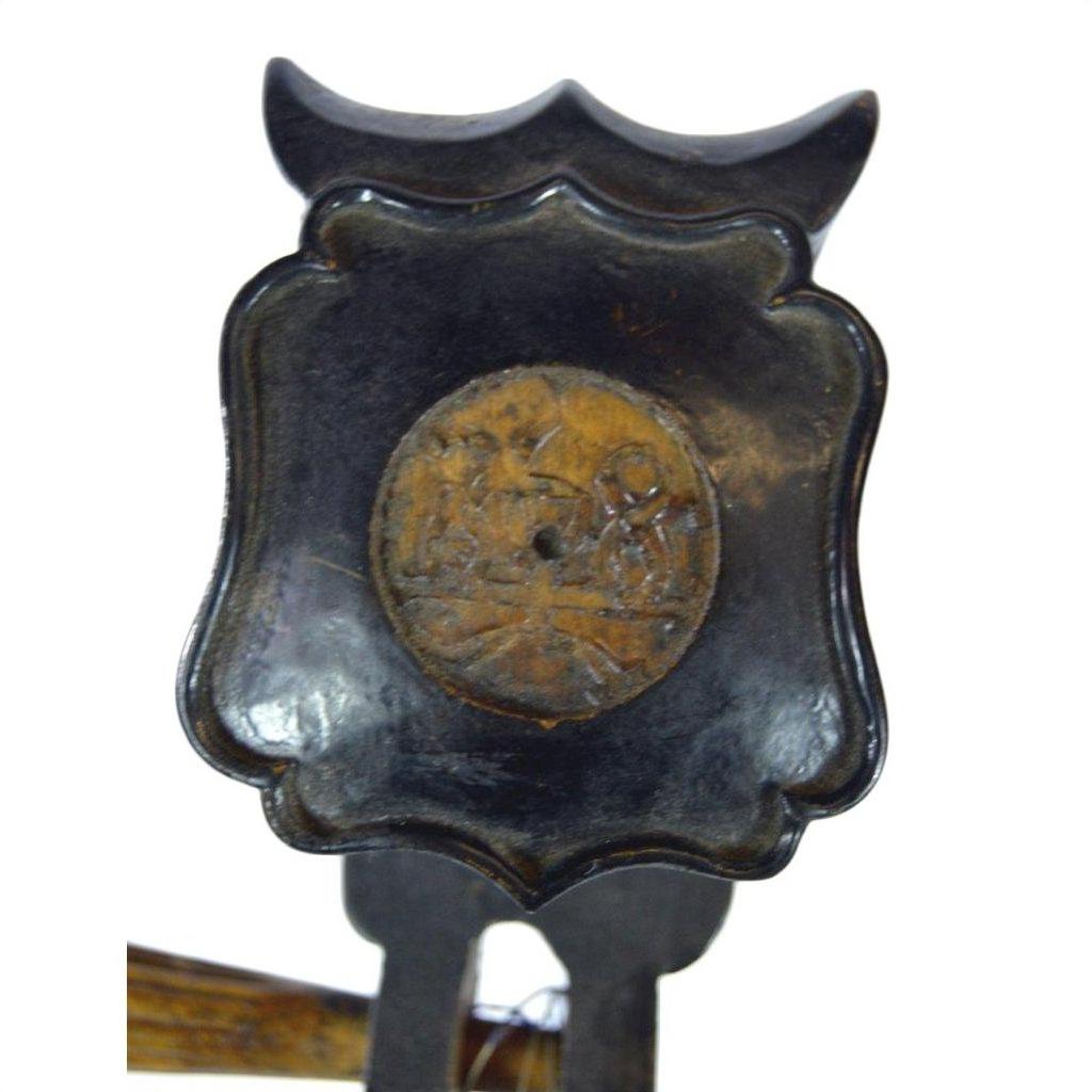 Close-up of a wooden Chinese PiPa lute with carved back and visible fret damage.
