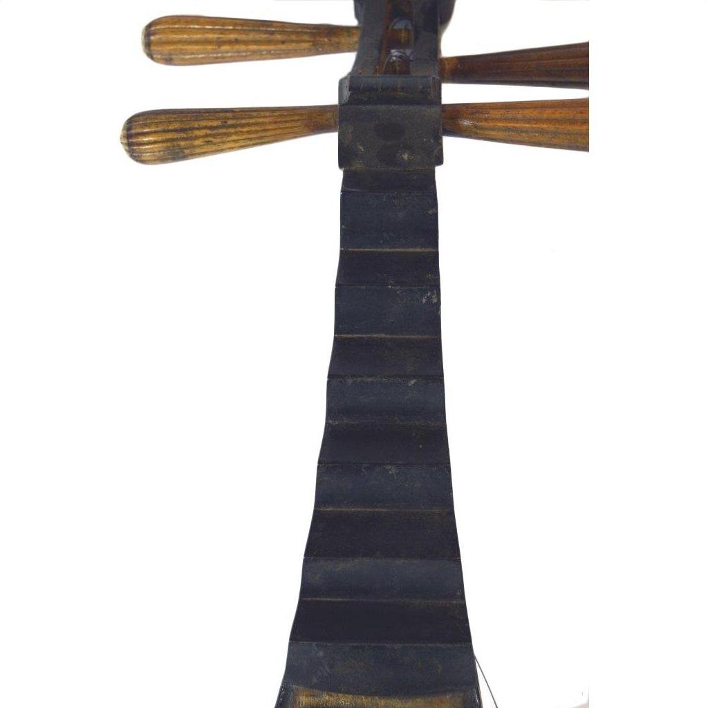 Close-up of black Chinese PiPa lute fingerboard with tuning pegs and a damaged fret on white background.