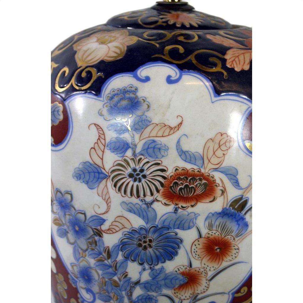 Blue, red, and gold porcelain lamp with floral patterns and ornate motifs, electric, shown in good condition.