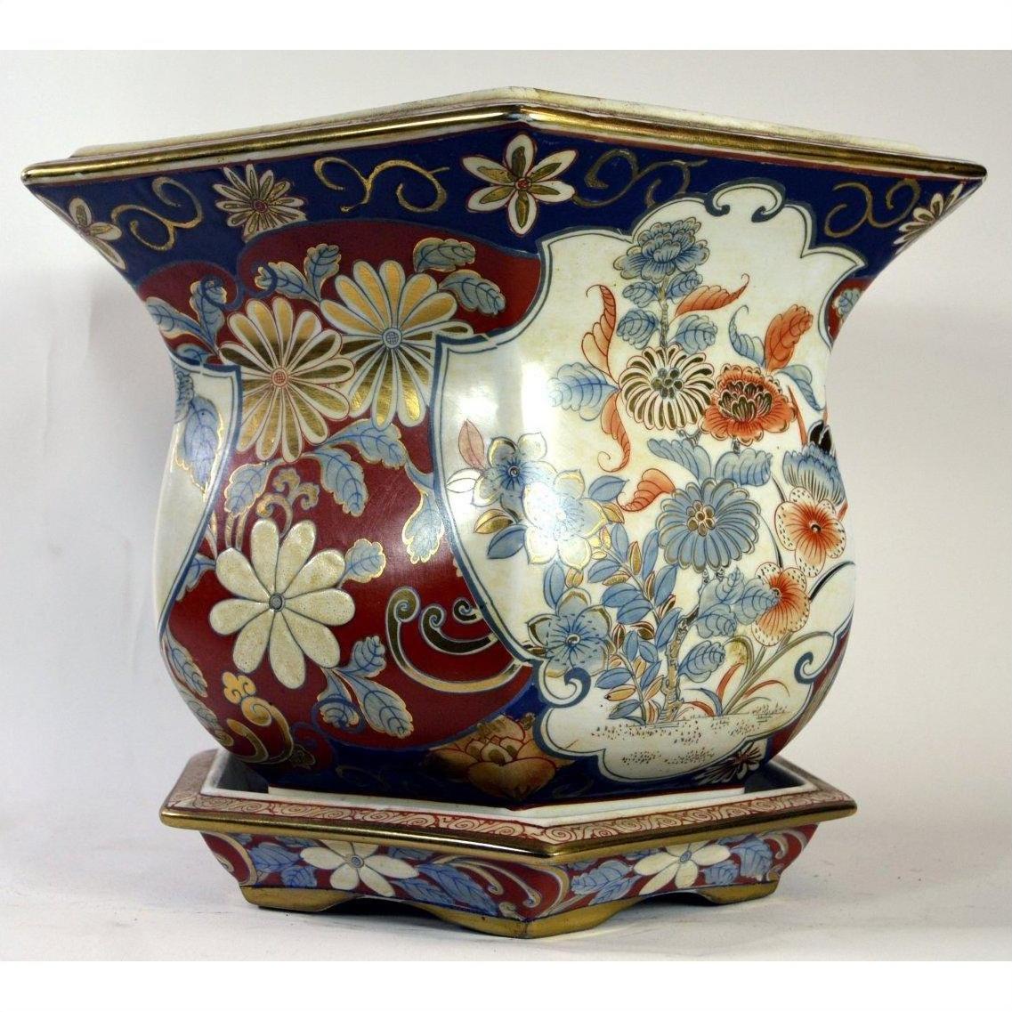 Close-up of blue, red, and gold floral Chinese porcelain planter on matching base.