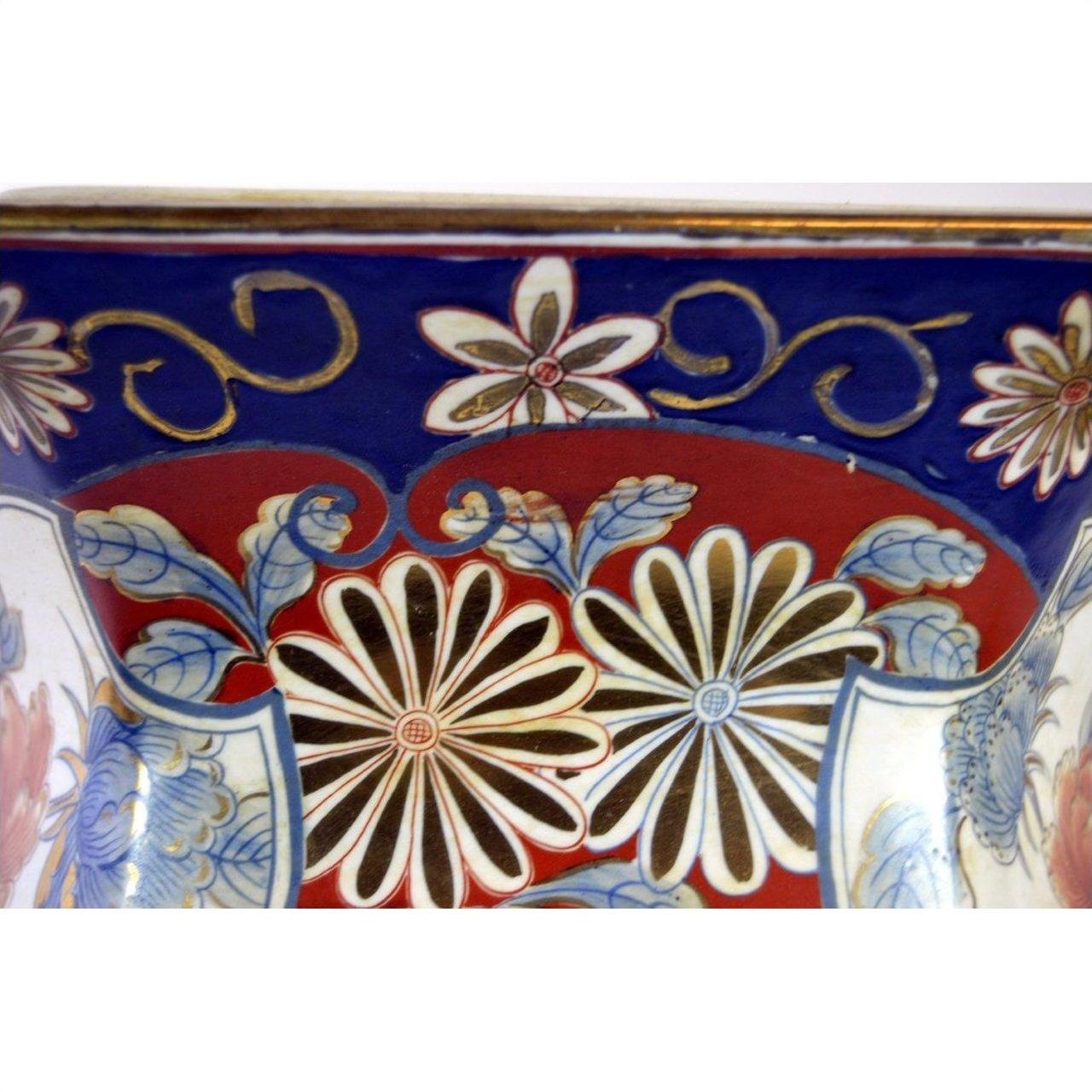 Close-up of a blue and red Chinese porcelain planter with hand-painted floral patterns.