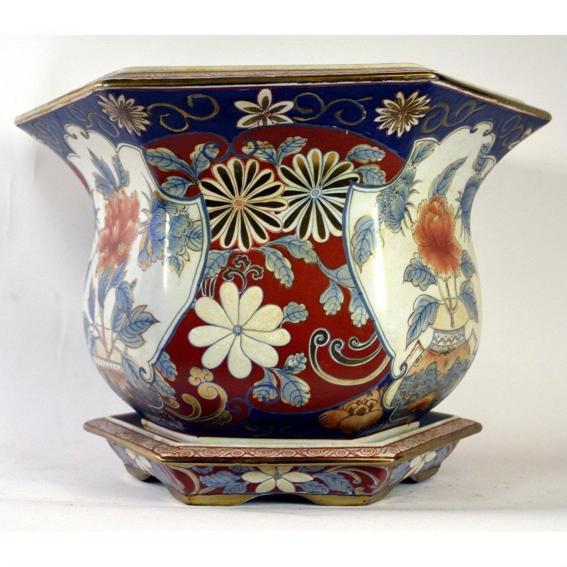 Red, blue, and white Chinese porcelain planter with hand-painted floral patterns on a matching base.