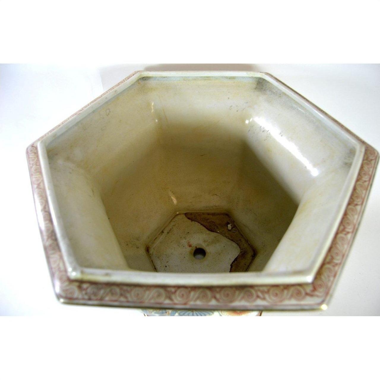 Multi-color porcelain hexagonal planter with bottom hole and decorative rim trim, top view.