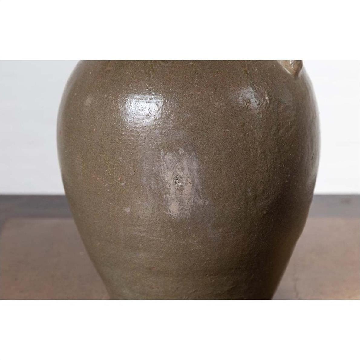 Brown glazed ceramic water jug with petite spout, faded central patch, Qing Dynasty, glossy finish.