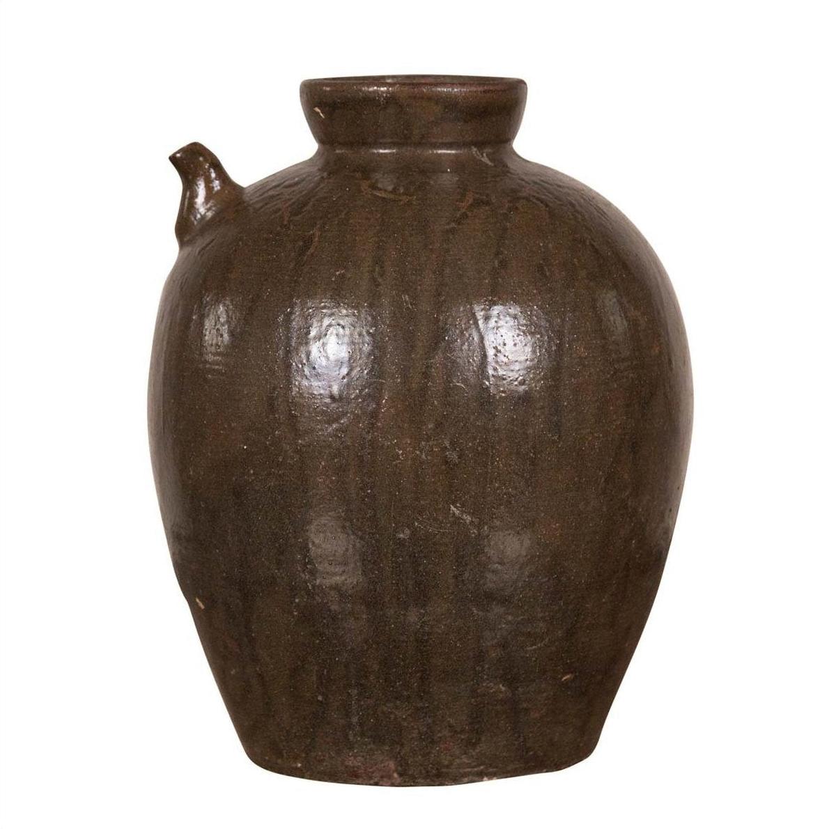 Dark brown glazed ceramic water jug with petite spout, round shape, on plain white background.