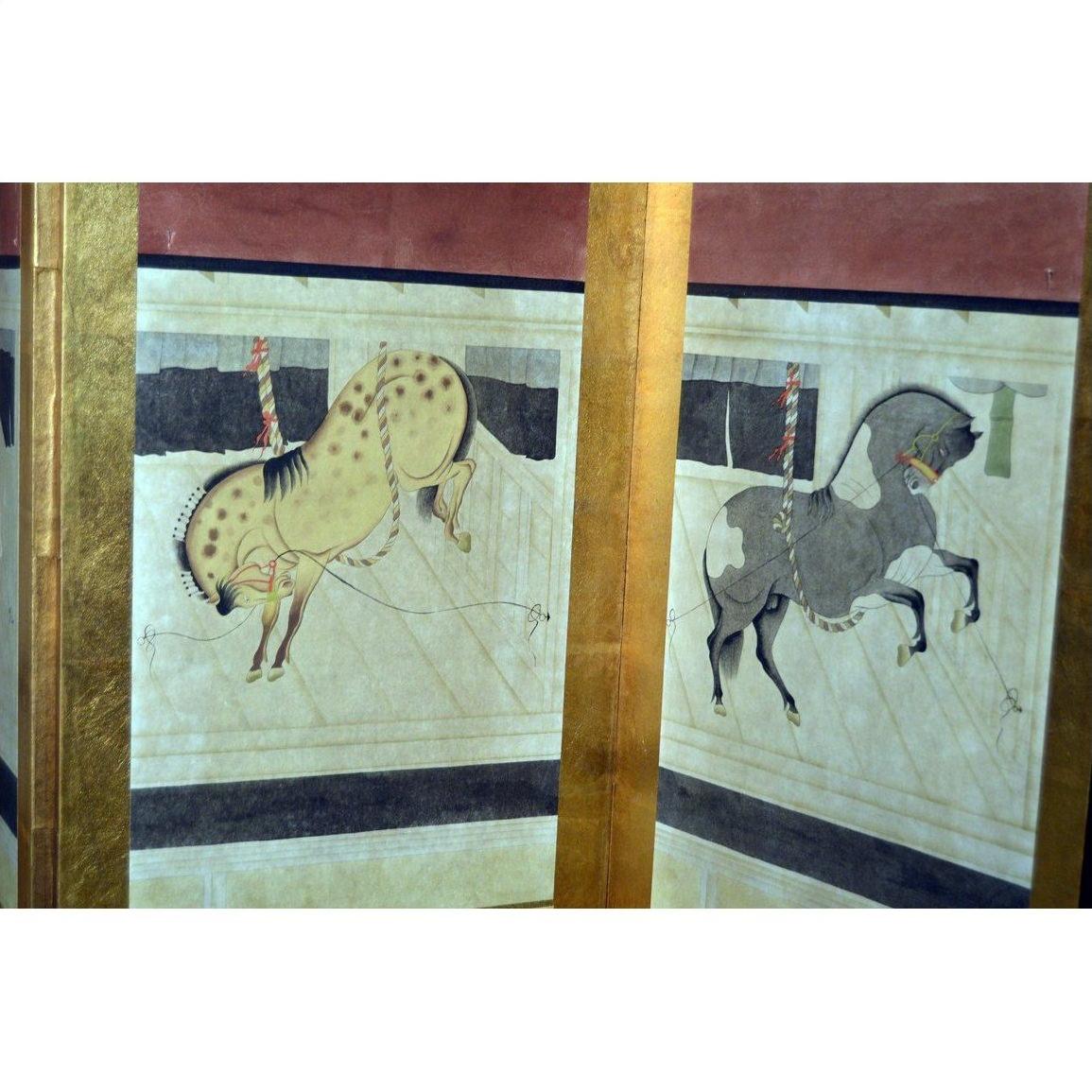 Spotted and gray hand painted horse figurines in arena setting, Chinese screen in background.