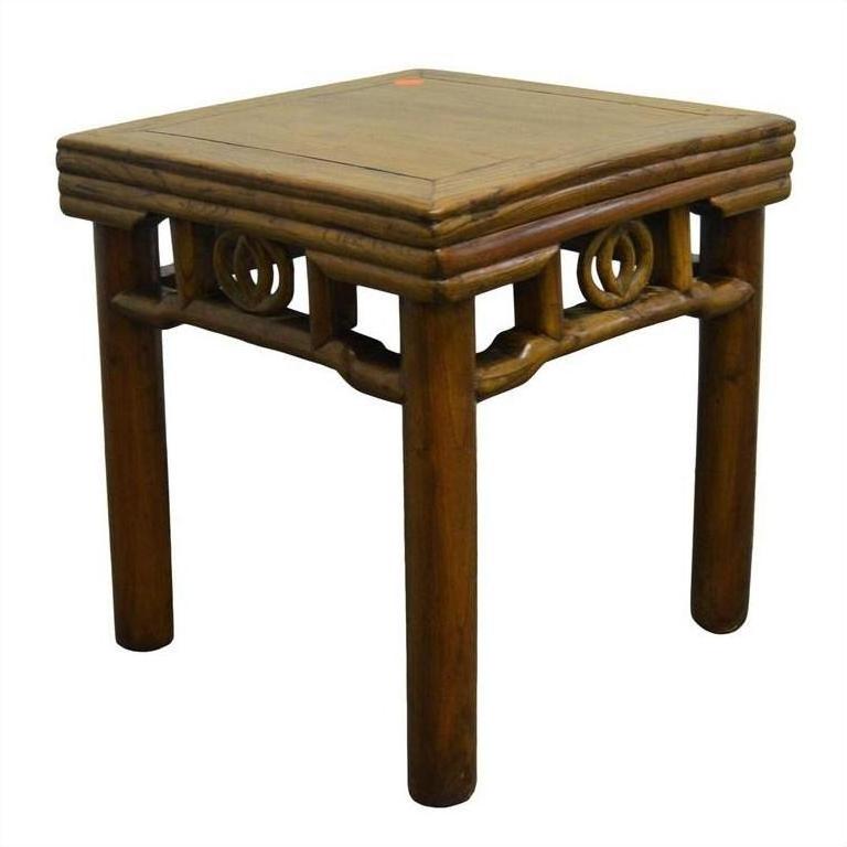Brown wooden Chinese side table with carved friezes under the tabletop, four legs, close-up view.