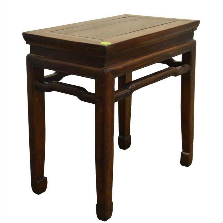 Dark wood Chinese side table with four straight legs and slightly raised rectangular top, studio background.