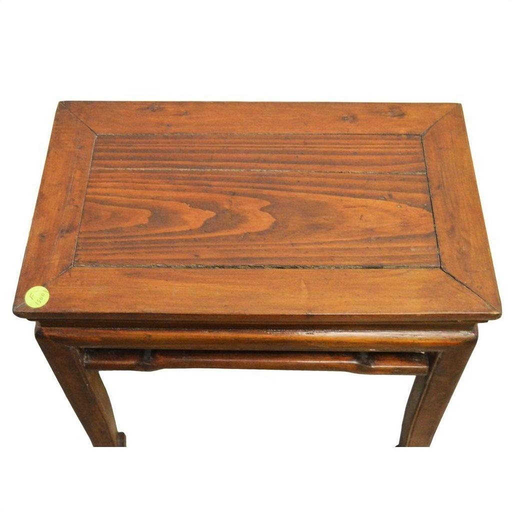 Brown wooden rectangular Chinese side table with simple design, small green sticker on top corner, top view.
