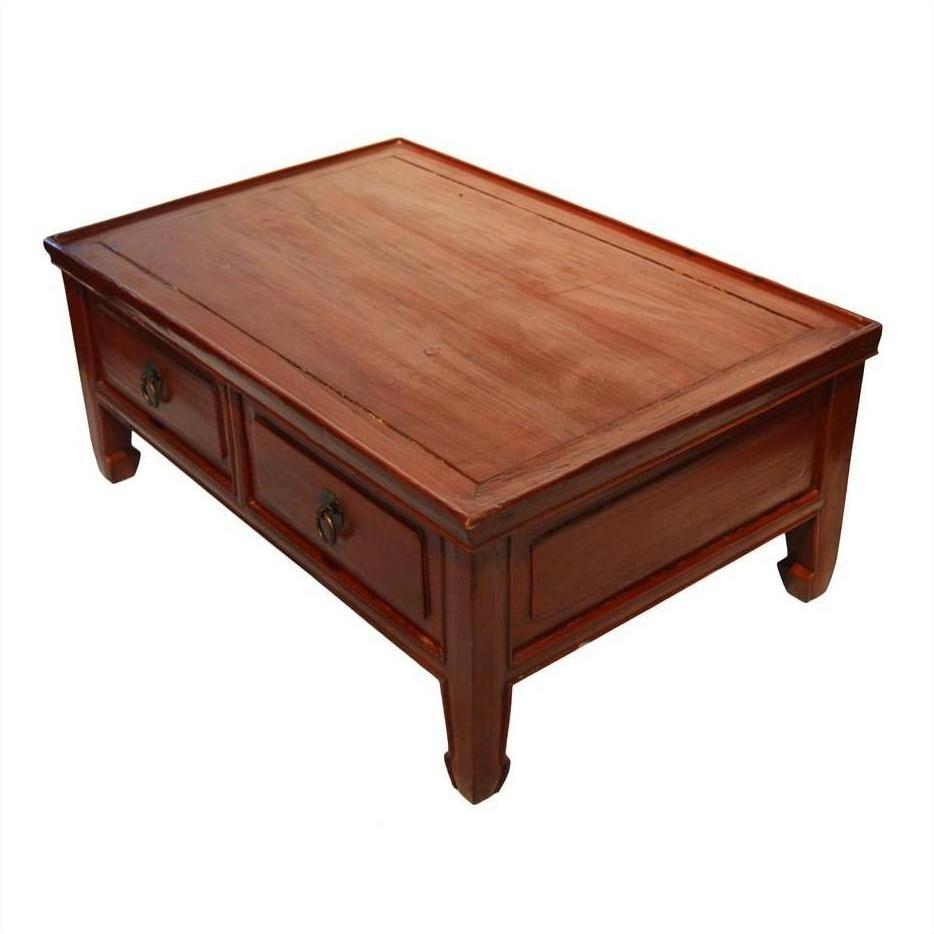 Warm brown wood Chinese low Kang coffee table with carved legs and two drawers, front view.
