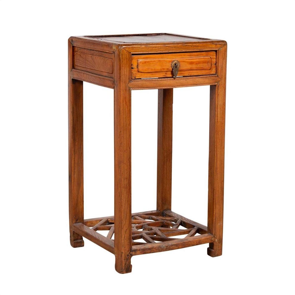 Brown elmwood lamp table with single drawer and cracked ice shelf at bottom, vintage style, indoor setting.