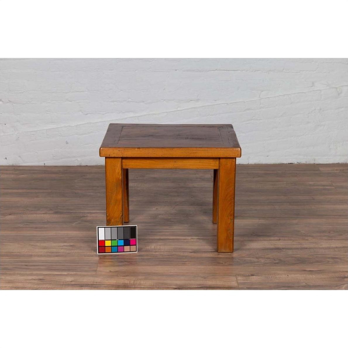 Natural wood Chinese vintage side table on wood floor, color card placed beside left leg, contemporary design.