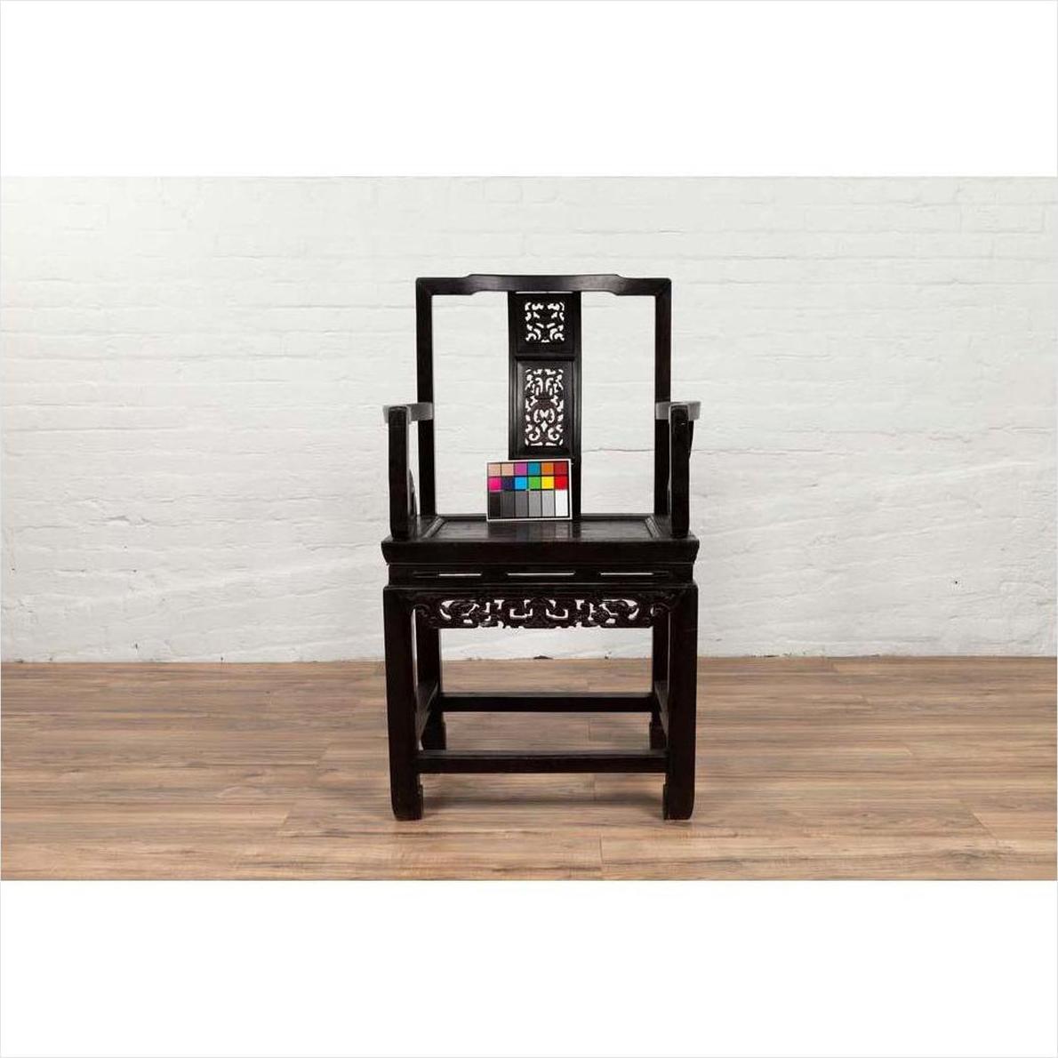 Dark wood Chinese wedding chair with curvy pierced splat and serpentine arms on wooden floor, color chart beside.