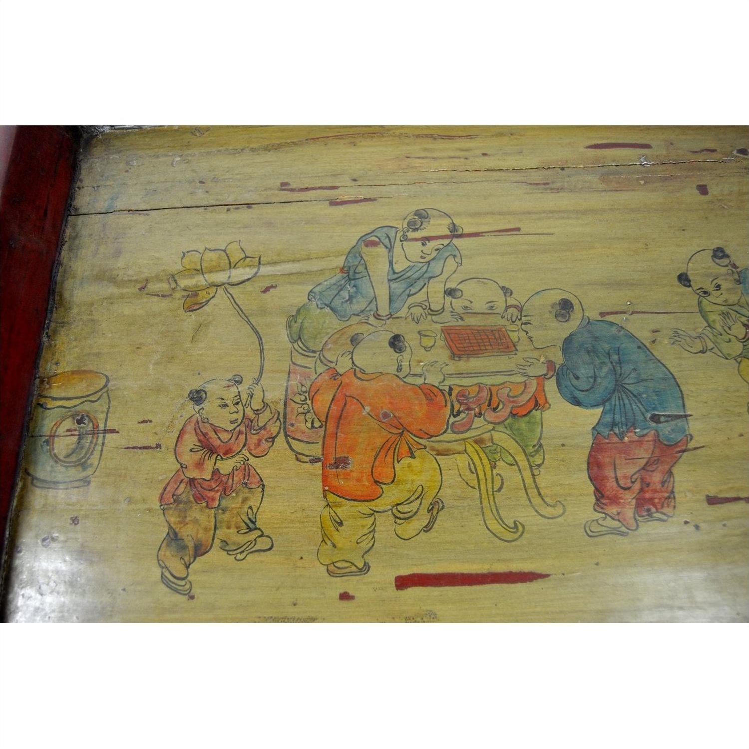 Brown wooden tray with hand-painted scene of children playing, one child holding a lotus flower, decorative detail.