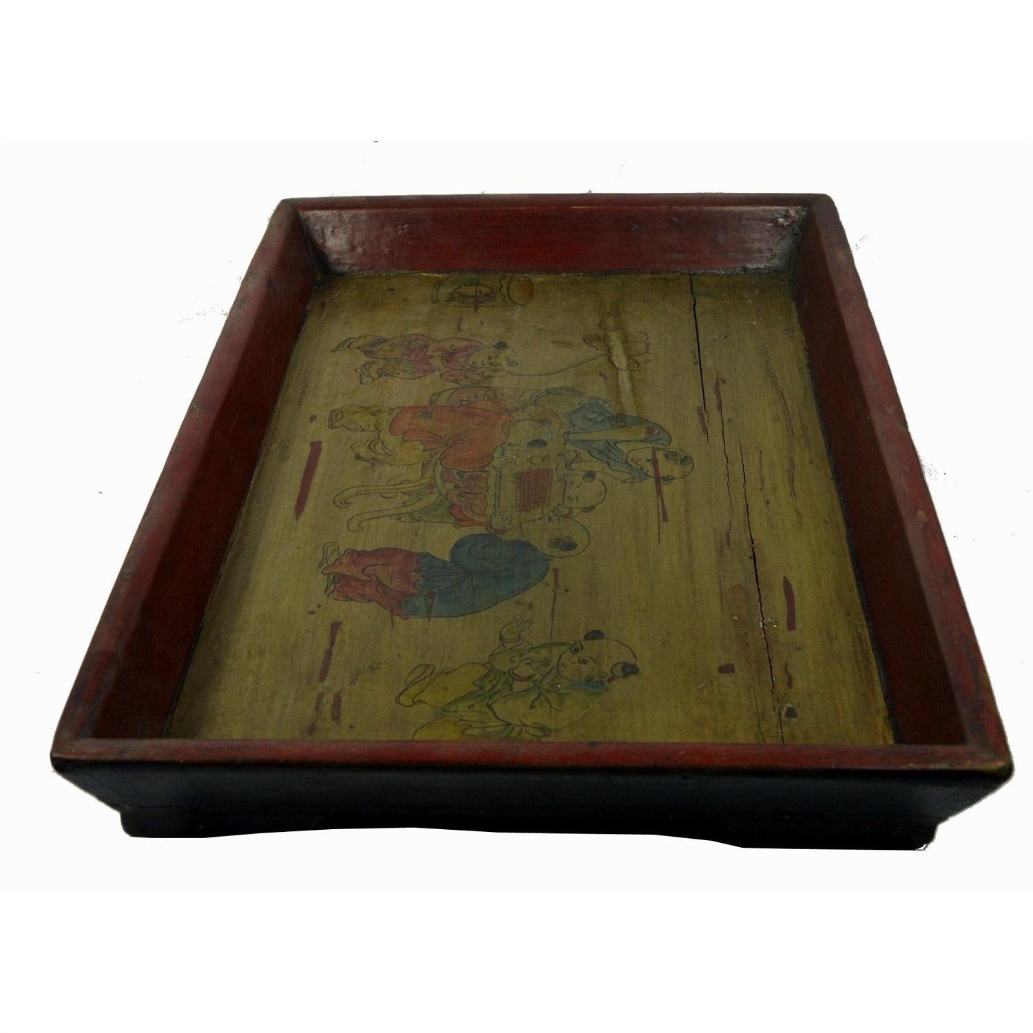 Close-up of Chinese wooden tray with red edges, yellowish base, and faded hand-painted figures, used condition.