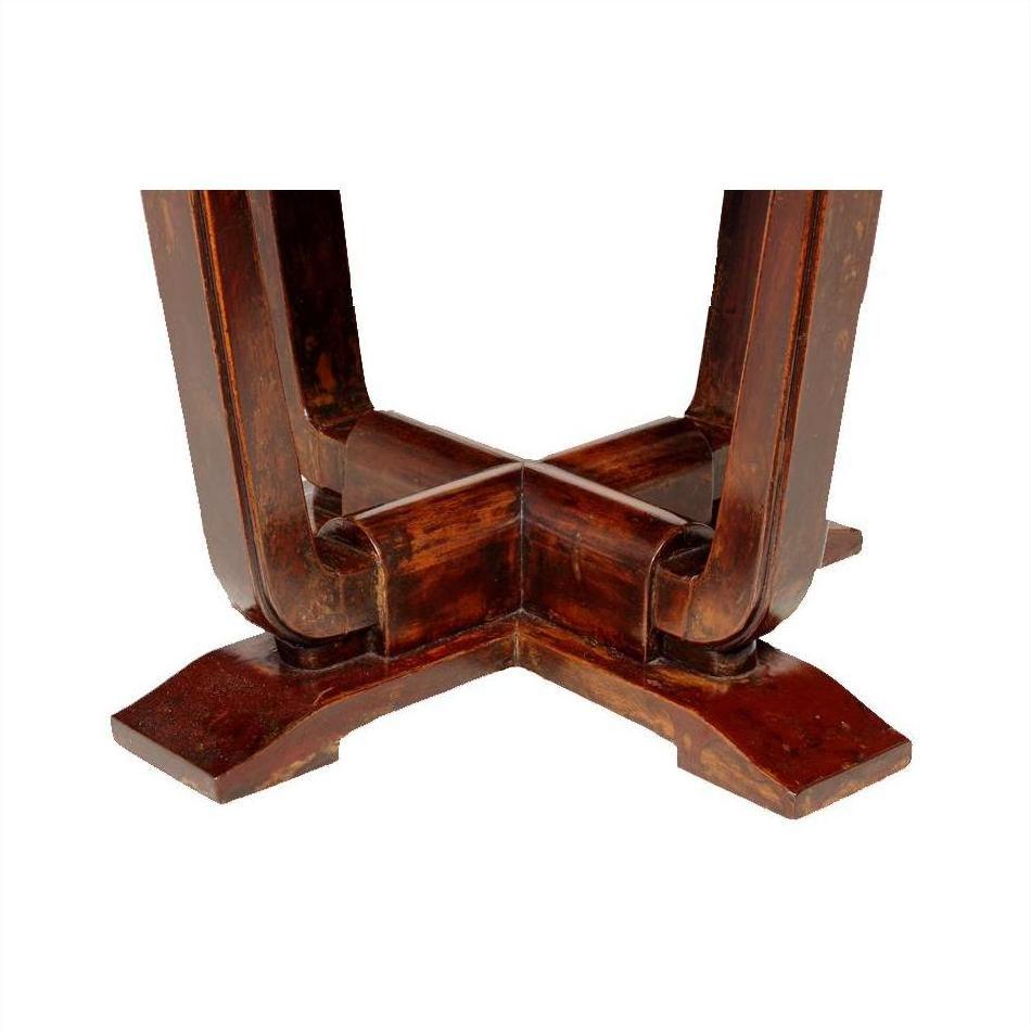 Close-up of natural wood Chinese Elmwood base with X-shaped support on circular side table.