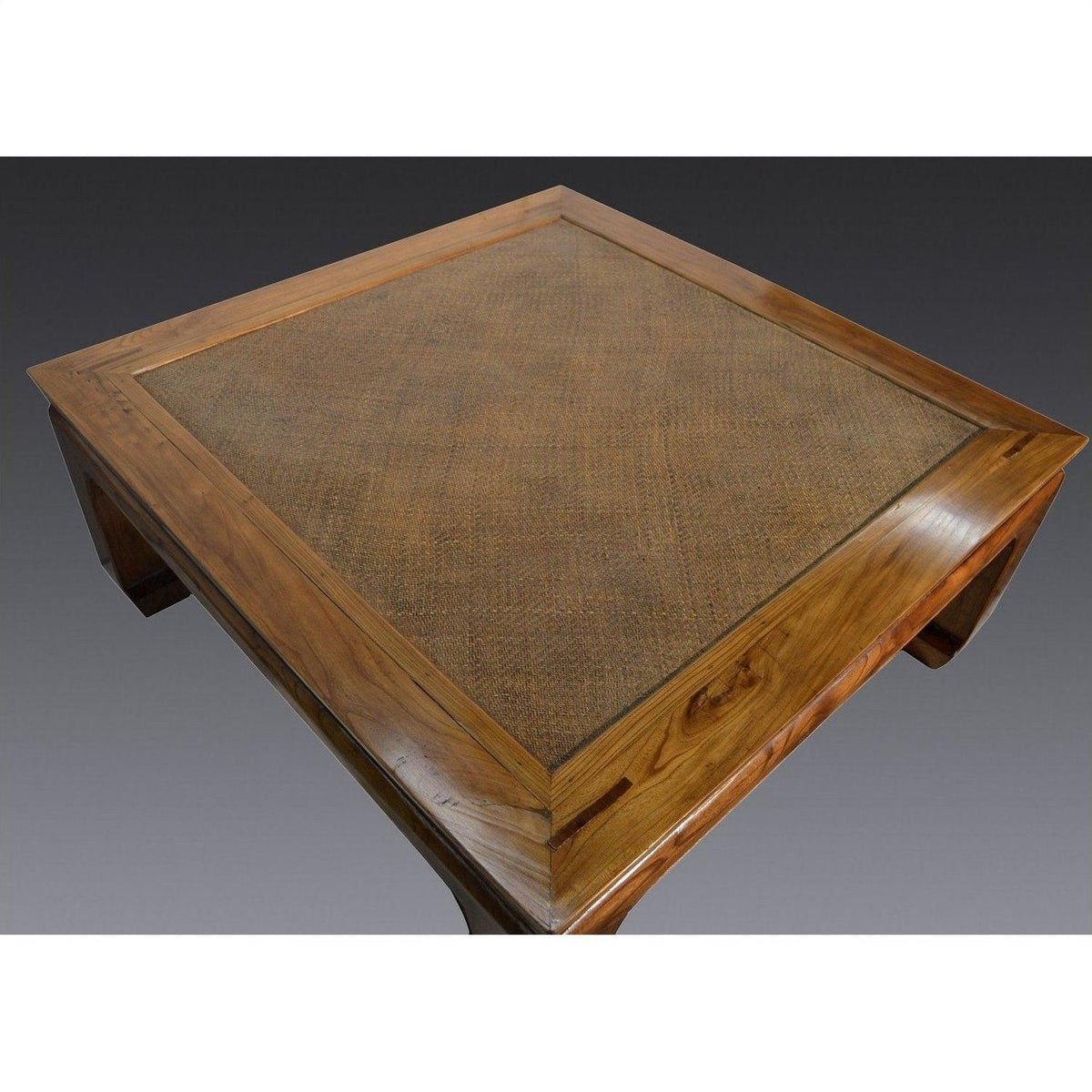 Light wood and rattan square coffee table with lacquer finish, pictured on a gray background.