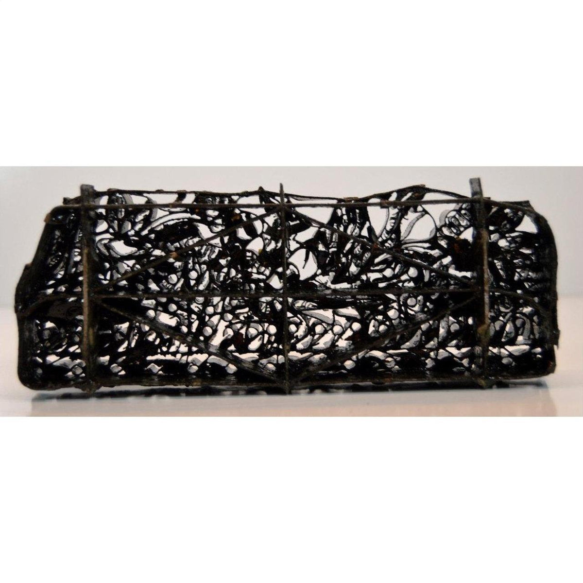 Copper Batik ink block with hand-designed tangled wire pattern, cylindrical shape, side view.