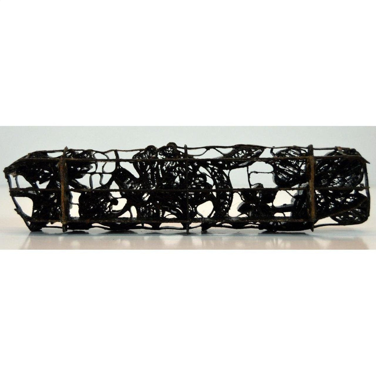 Copper metal rectangular tray with ornate floral scrollwork, antique ink block style, close-up view.
