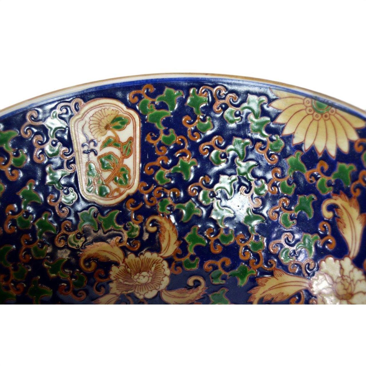Close-up of blue, green, and gold Ming porcelain bowl with intricate patterns in very good condition.