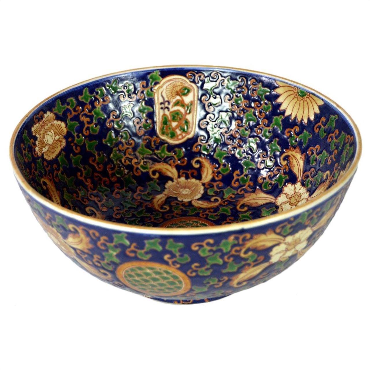 Blue, gold, and green porcelain Ming bowl with intricate floral patterns, close-up view.