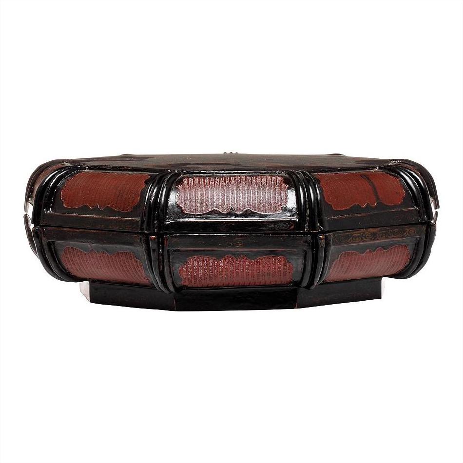 Black and red lacquered basket with ornate curved panels and glossy finish, close-up on white background.