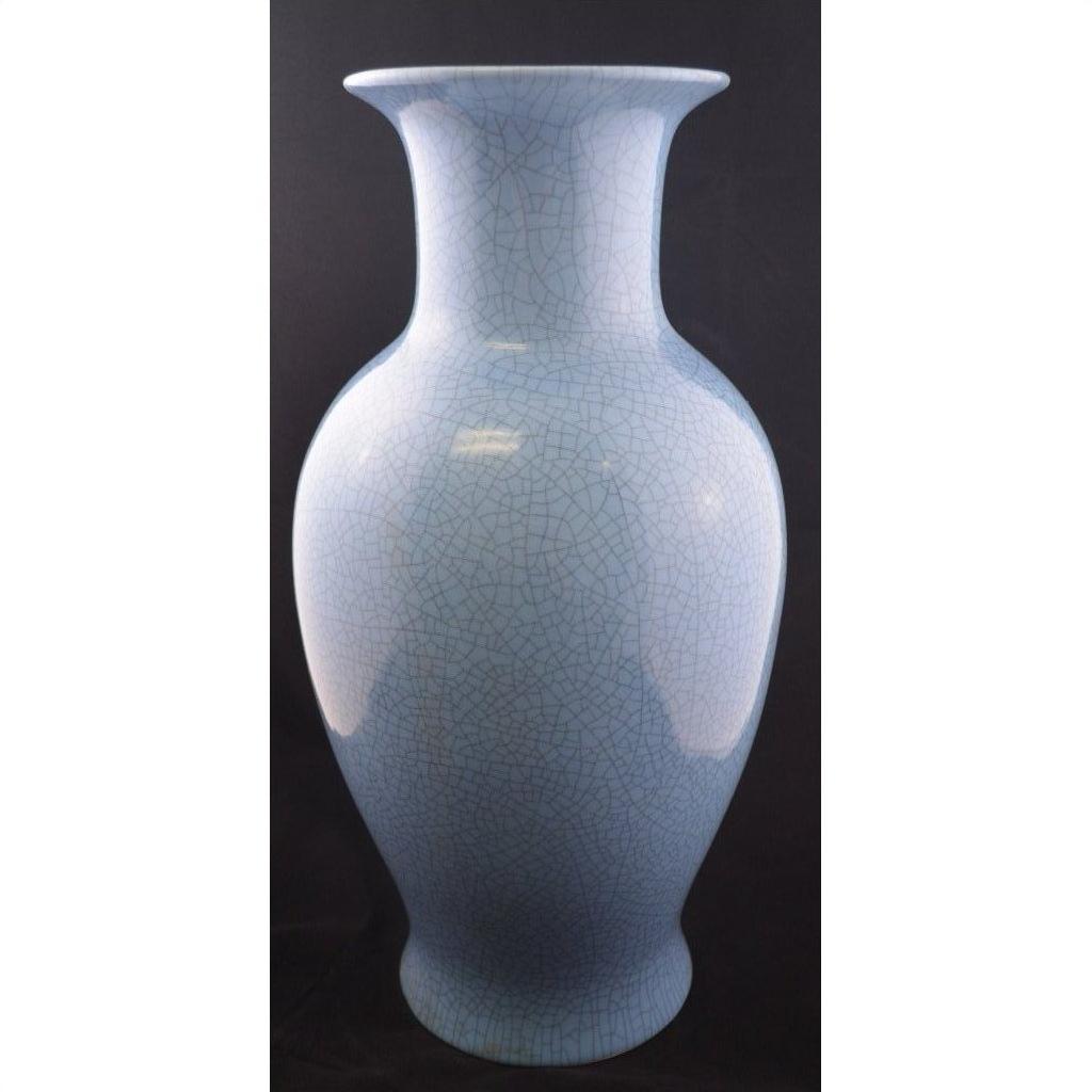 Light blue crackle porcelain vase with wide rim, tall design, close-up against black background.