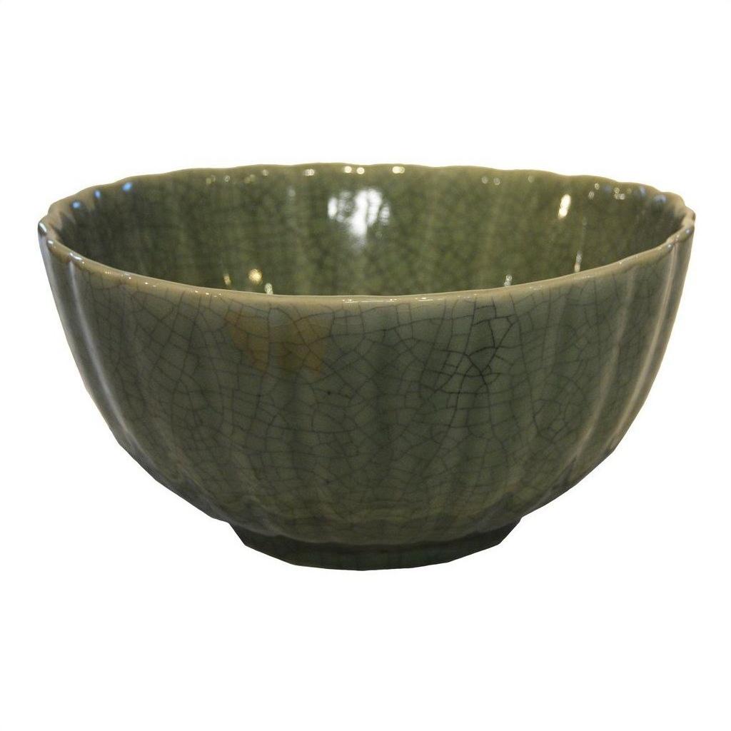 Close-up of a white celadon porcelain bowl with crackled glaze and scalloped rim on a modern white background.