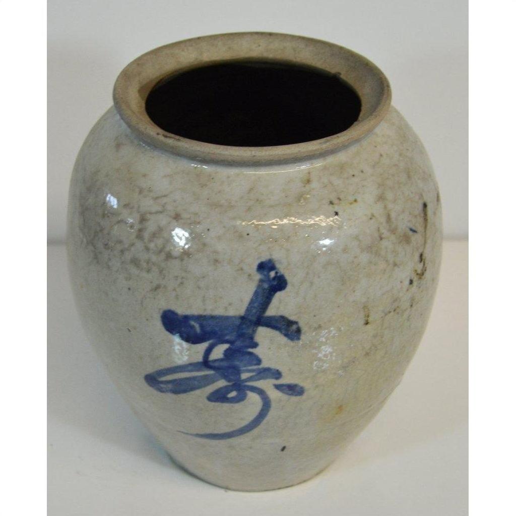White ceramic Japanese crackle vase with blue calligraphy, antique style, top view.