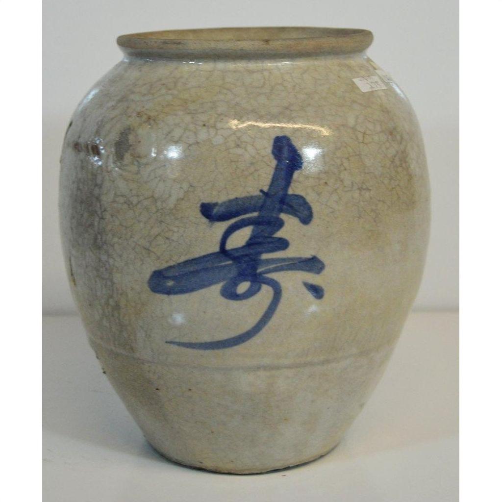 Close-up of cream crackle-glazed Japanese vase with hand-painted calligraphy, ceramic surface visible.
