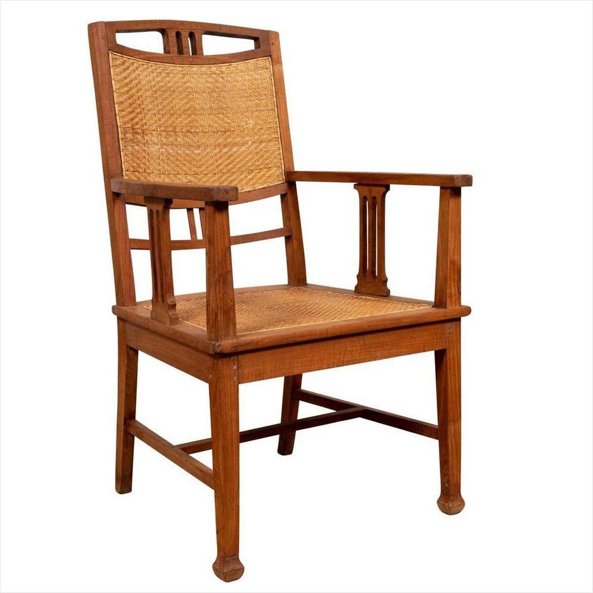 Brown teak armchair with rattan seat and back, Dutch Colonial Javanese style, featuring triglyph-inspired motifs.