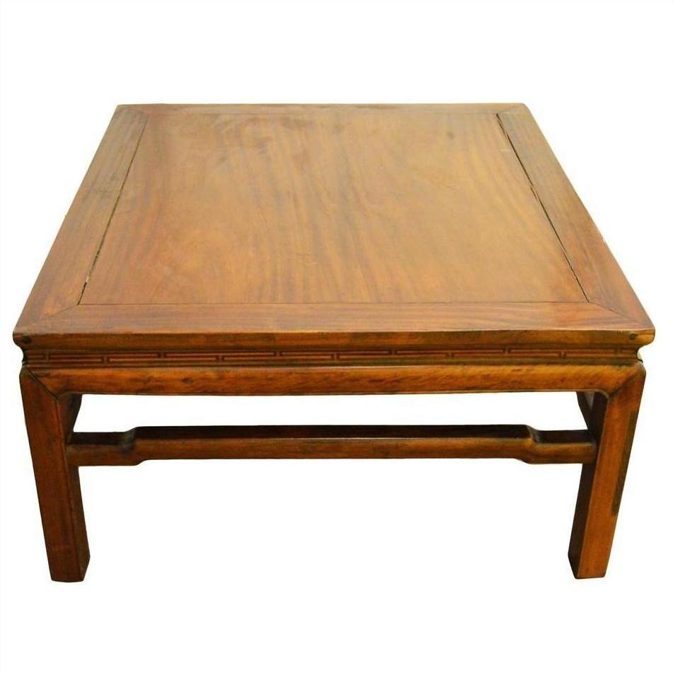 Brown Yumu wood coffee table with straight legs, hand-carved 19th century, against a plain background.