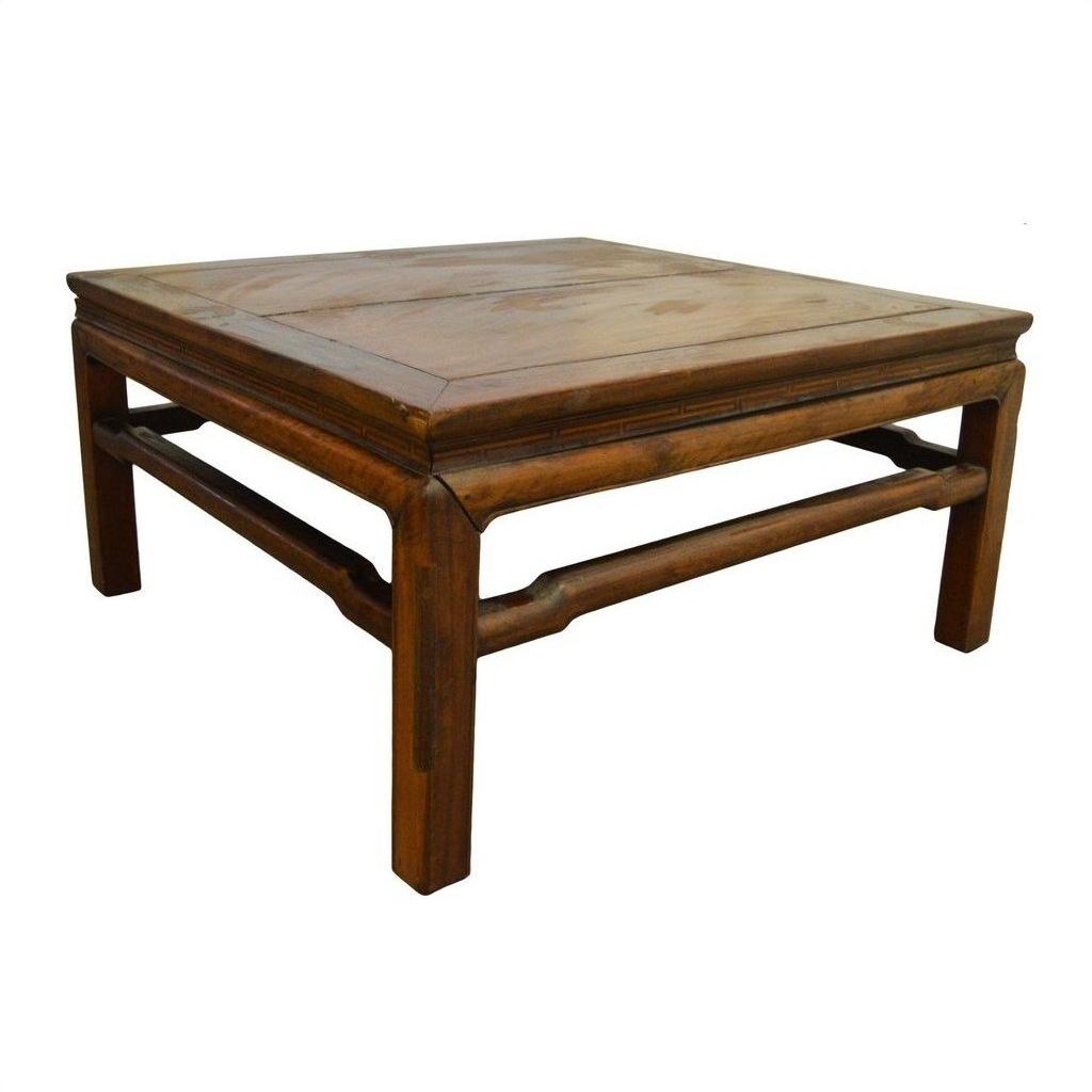 Natural Yumu wood square coffee table with hand-carved legs and natural finish on a white background.