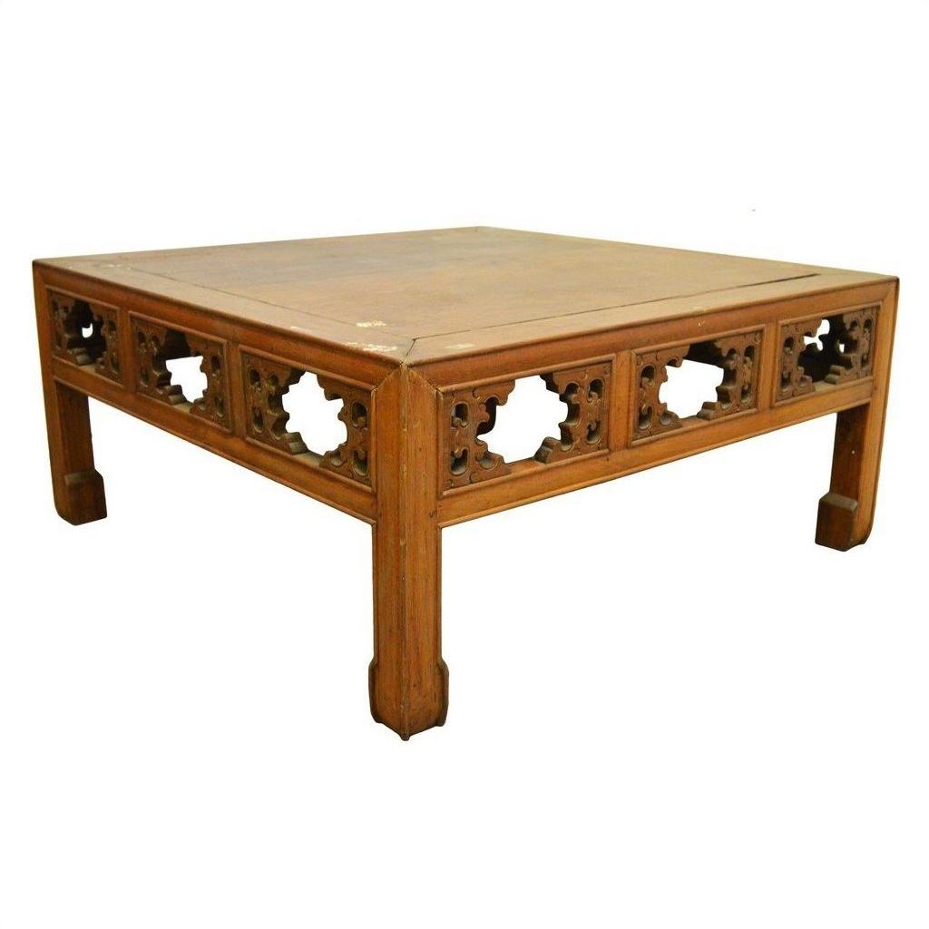 Square elm wood coffee table with hand-carved geometric sides and sturdy legs, front view.