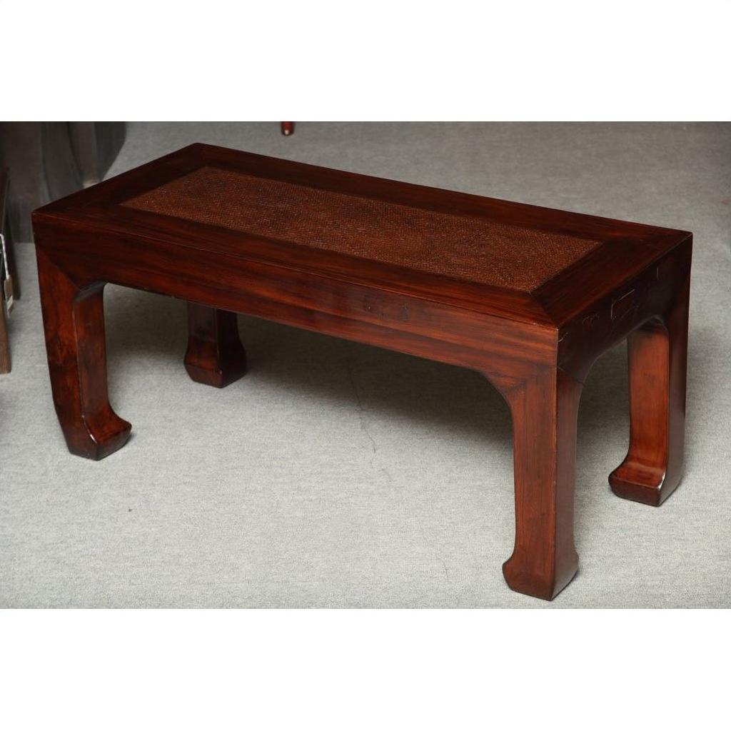 Antique elm wood table with a flat top and four curved legs on a light-colored floor.
