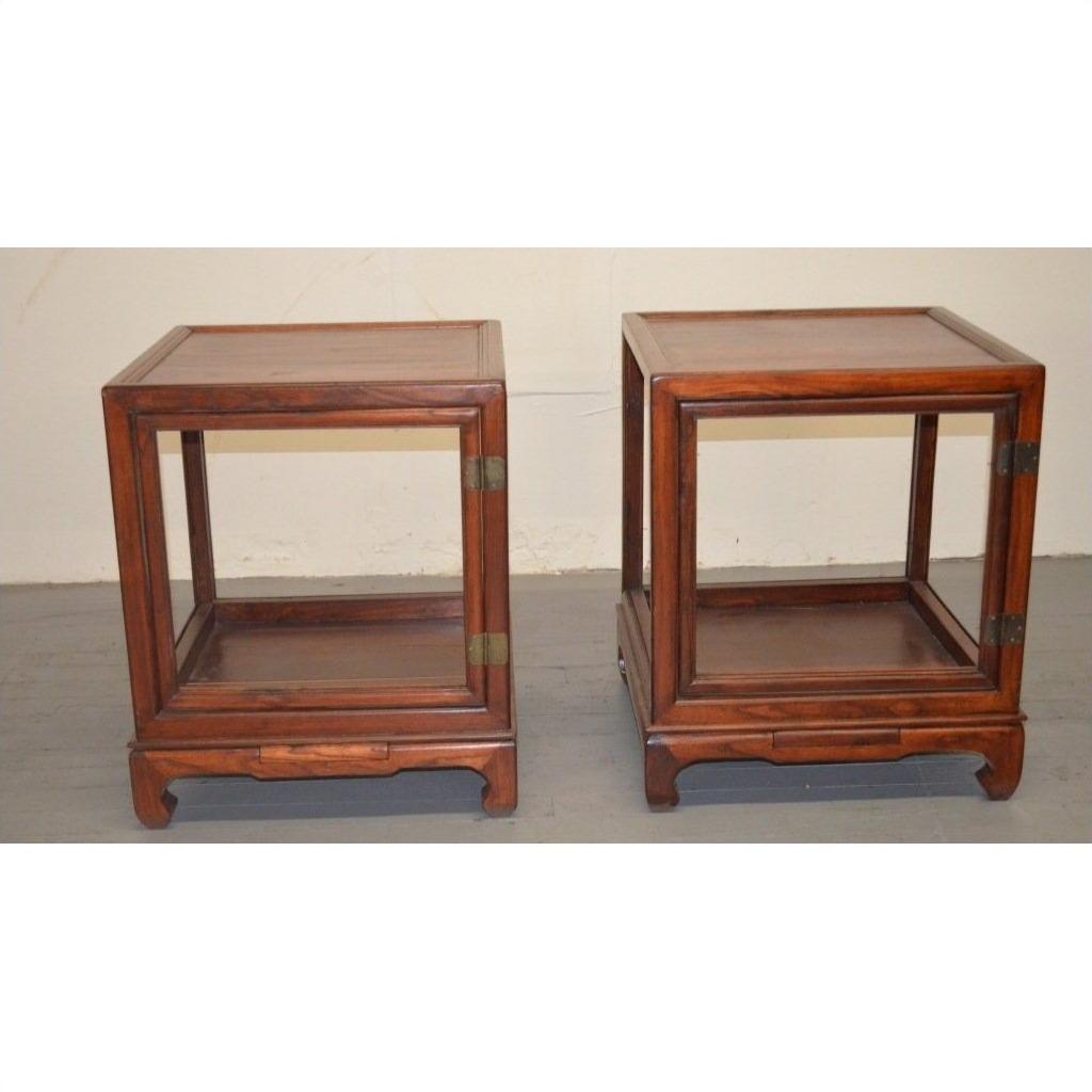 Brown wooden side table with open sides and a lower shelf, traditional design, studio background.