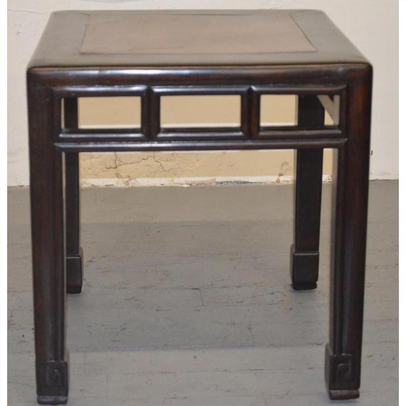 Dark wood stool with straight legs, geometric burlwood inlay pattern beneath seat, studio close-up.