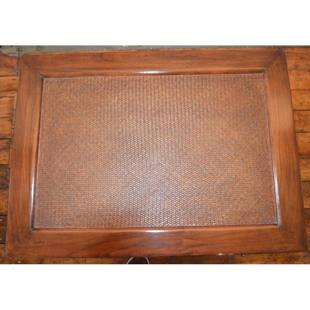 Brown Elmwood stool/table with a rectangular rattan tray with wooden frame, displayed on a wooden surface.