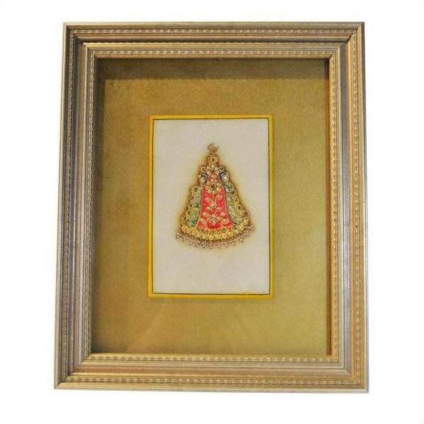 Close-up of framed Indian artwork featuring a small Hindu deity in red and gold on a radiant golden background.